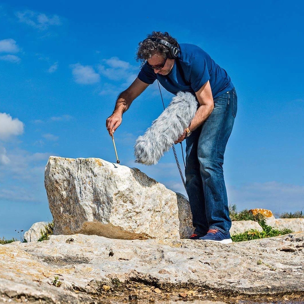 Renzo Spiteri recording stone bell at Ta' Cenc cliffs (Gozo)